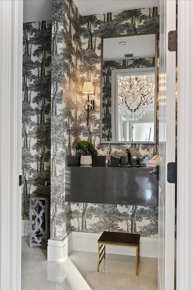 bar featuring an inviting chandelier and light tile floors