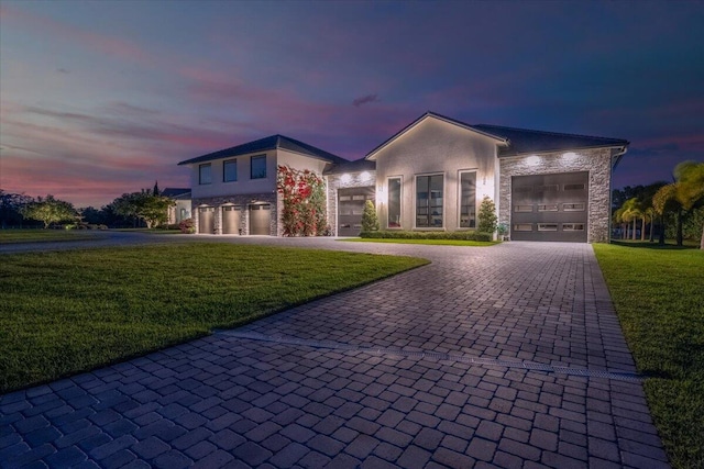 view of front of property with a lawn and a garage