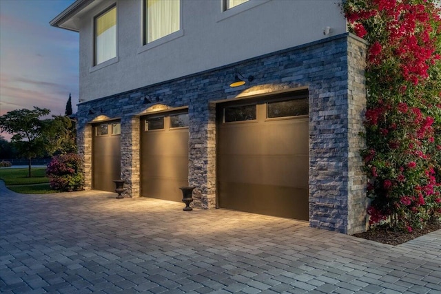 view of garage at dusk