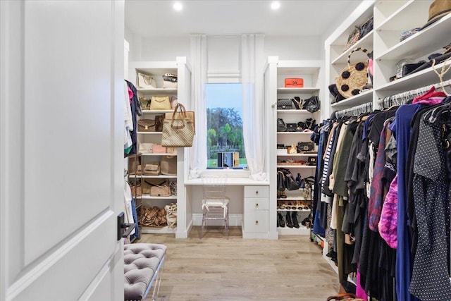 walk in closet featuring light hardwood / wood-style flooring