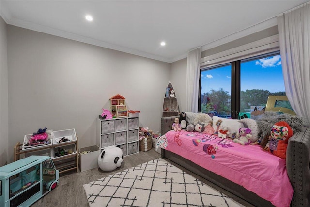 bedroom featuring ornamental molding and light hardwood / wood-style flooring