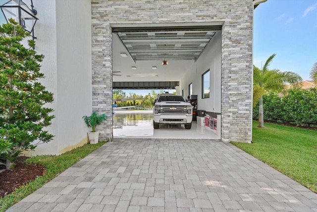 view of parking / parking lot featuring a yard and a carport