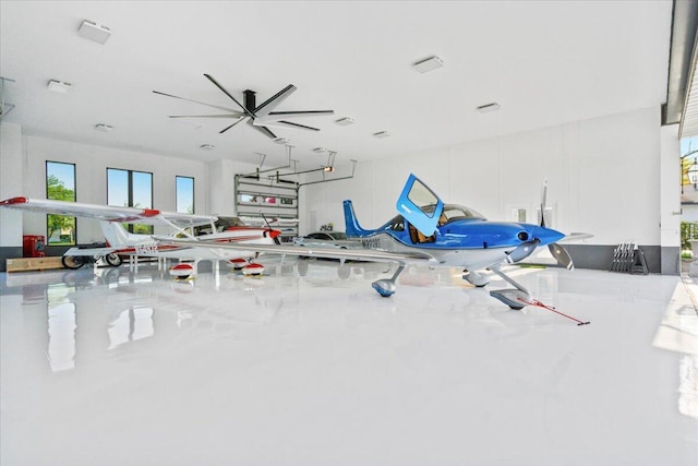 workout room with concrete flooring and ceiling fan