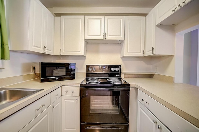 kitchen featuring black appliances and white cabinetry