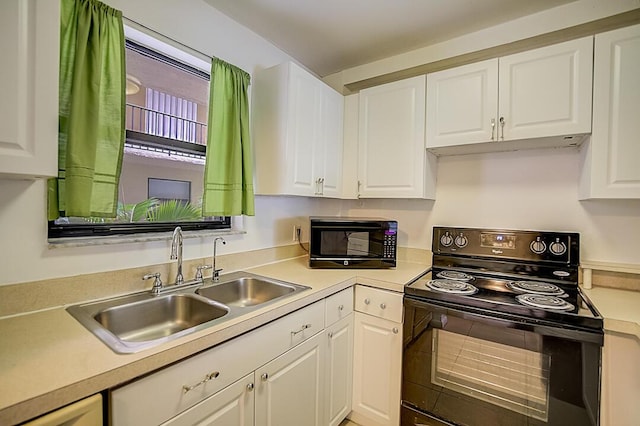 kitchen featuring white cabinets, black appliances, and sink