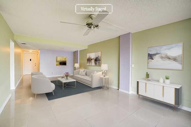 tiled living room with a textured ceiling and ceiling fan