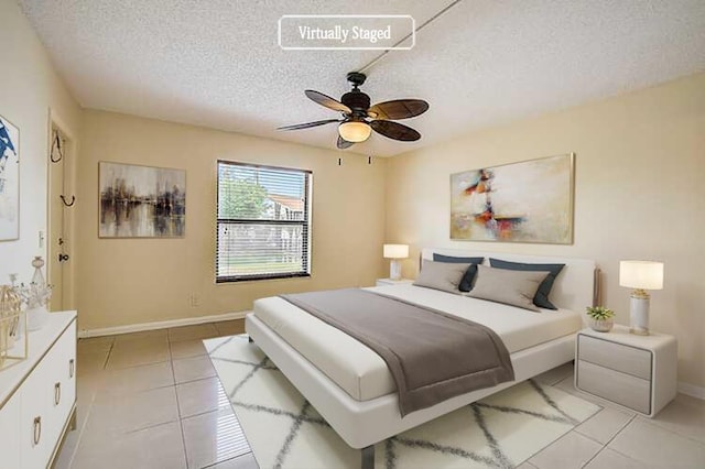 tiled bedroom with a textured ceiling and ceiling fan