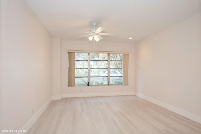 empty room with ceiling fan and light wood-type flooring