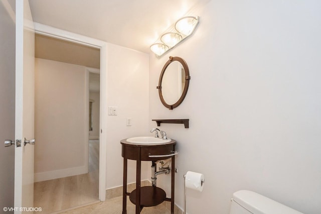 bathroom featuring sink and toilet