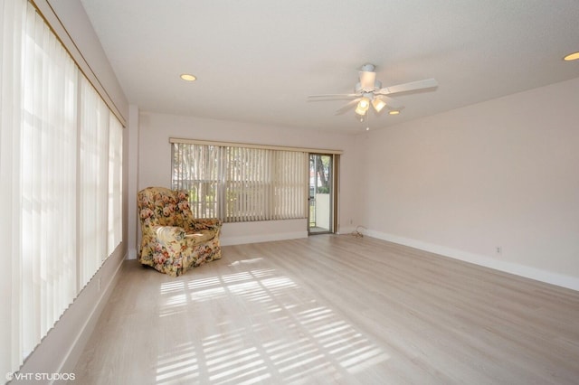 unfurnished room with ceiling fan and light wood-type flooring