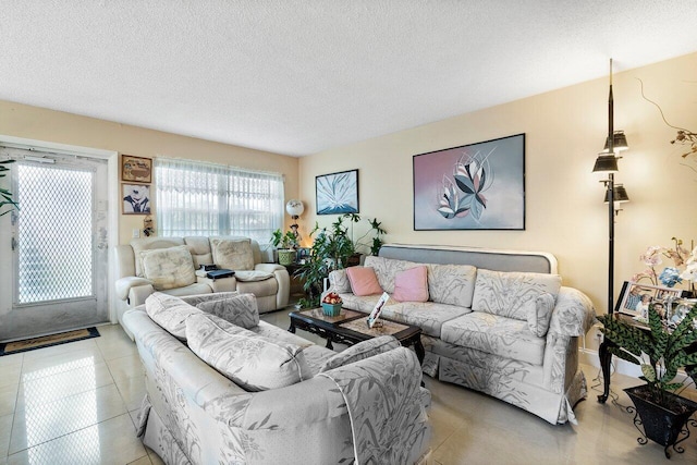 living room featuring light tile flooring and a textured ceiling