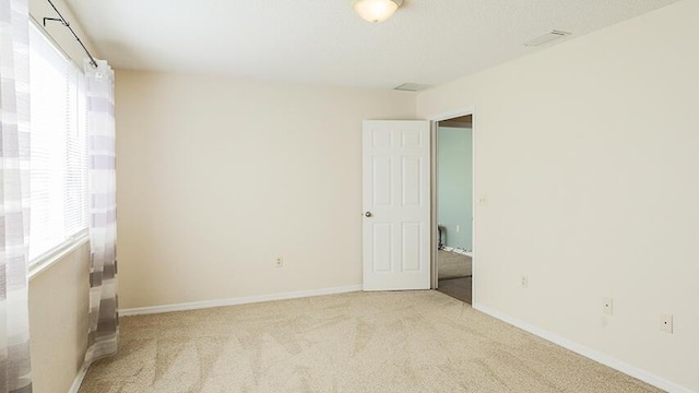 empty room featuring light carpet