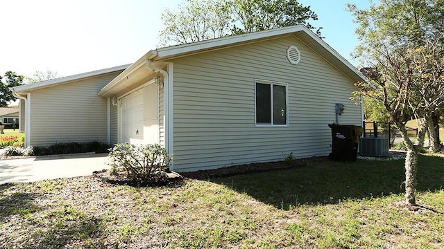 view of side of property featuring a lawn and central air condition unit