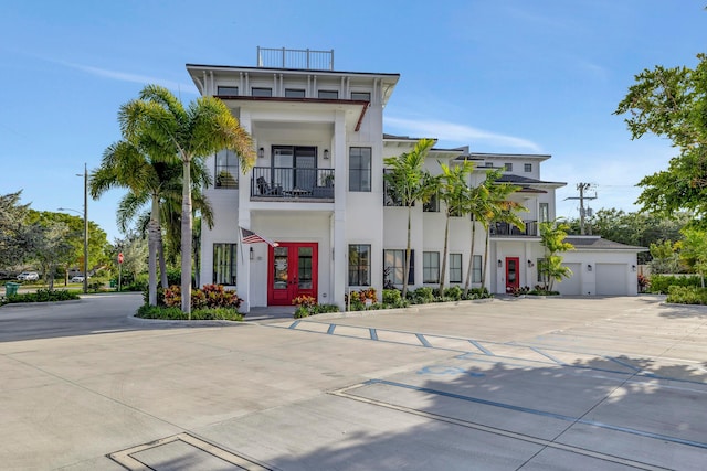 view of front of property with a balcony and a garage