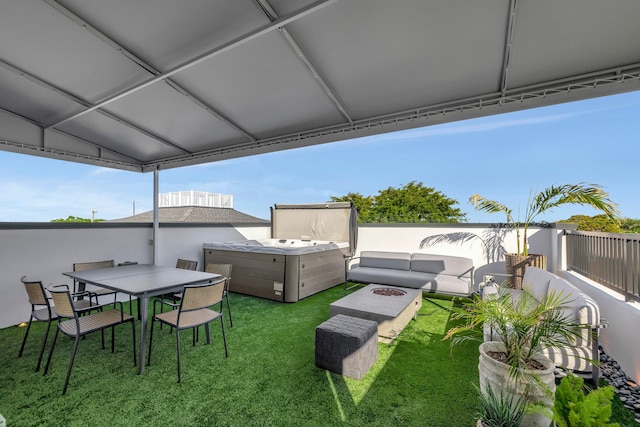 view of yard with outdoor lounge area and a hot tub