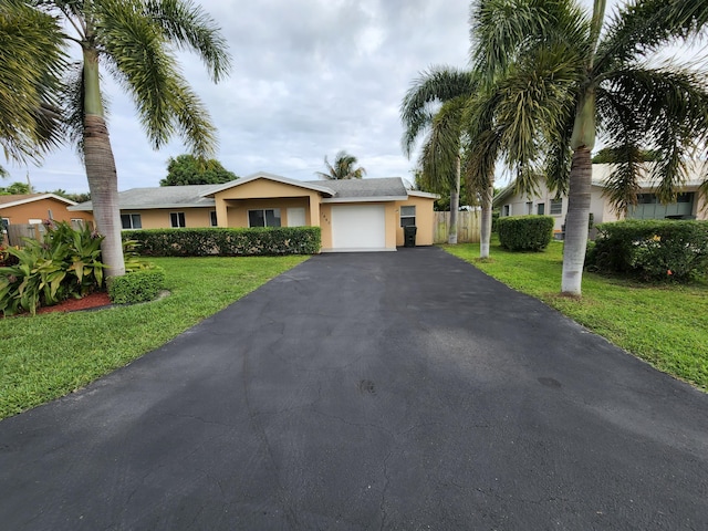 single story home with a front lawn and a garage