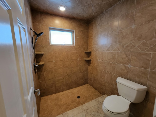 bathroom with tile walls, toilet, and tiled shower