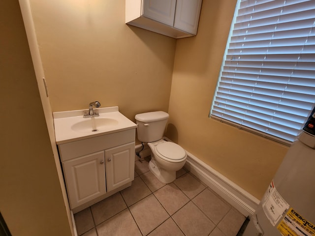 bathroom featuring vanity, tile flooring, and toilet