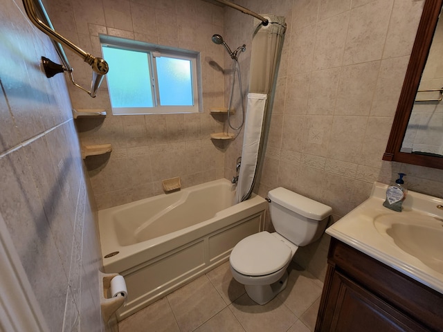 full bathroom with toilet, tiled shower / bath combo, vanity, tile walls, and tile flooring