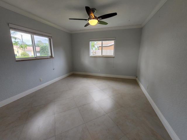 spare room featuring crown molding, ceiling fan, and light tile flooring