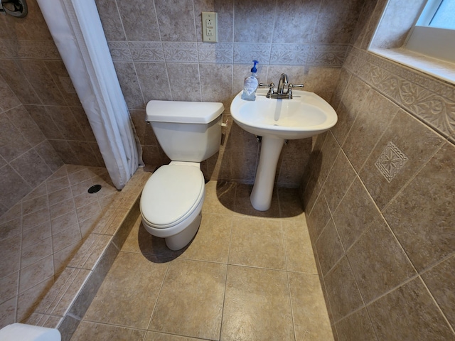 bathroom featuring toilet, tile walls, walk in shower, backsplash, and tile flooring