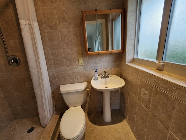 bathroom with toilet, tile walls, walk in shower, backsplash, and tile floors