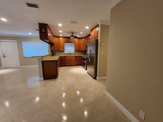 kitchen featuring stainless steel fridge, ceiling fan, sink, crown molding, and tasteful backsplash