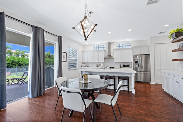 dining room featuring a notable chandelier and dark hardwood / wood-style floors