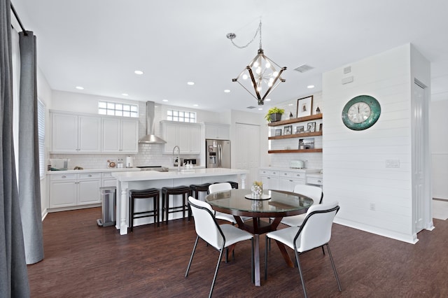 dining space featuring a notable chandelier and dark hardwood / wood-style flooring