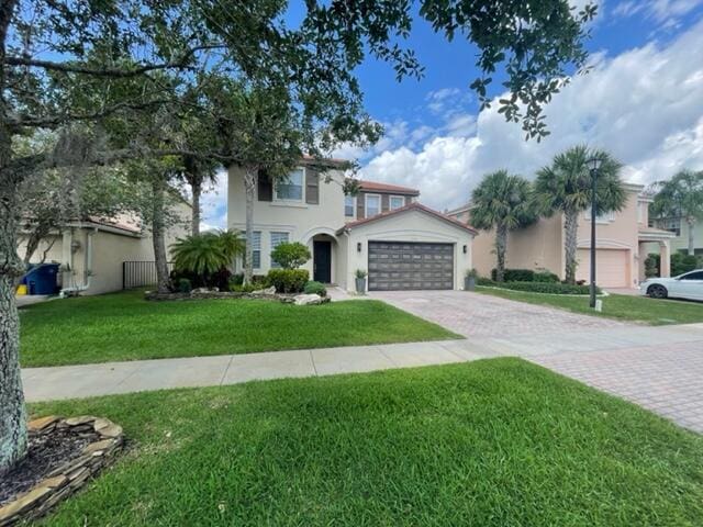 view of front of home featuring a front yard and a garage