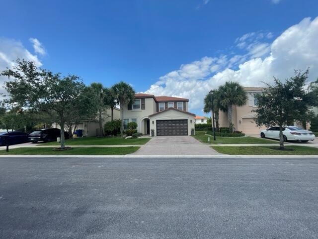 view of front of house with a front lawn and a garage