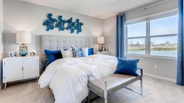 bedroom with a water view and light colored carpet