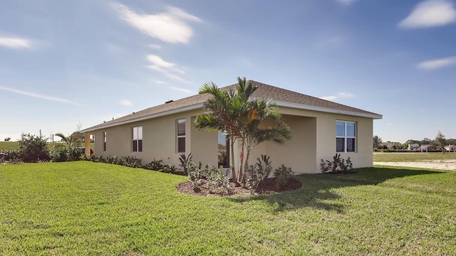 view of side of home with a lawn