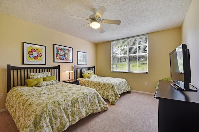 carpeted bedroom featuring ceiling fan and a textured ceiling