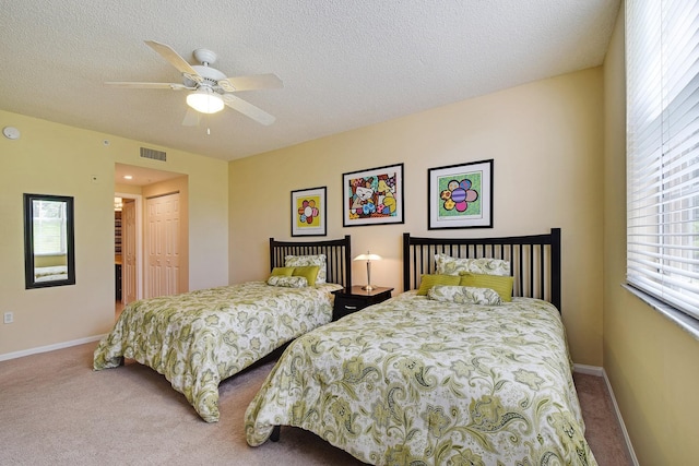 bedroom featuring a closet, multiple windows, and light colored carpet