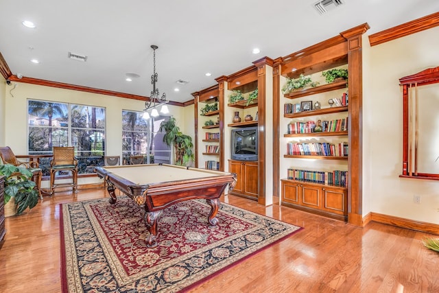 recreation room featuring billiards, crown molding, built in shelves, and light wood-type flooring