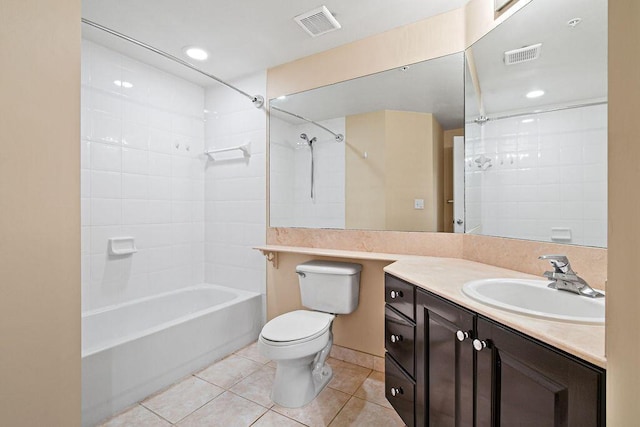 full bathroom with tiled shower / bath combo, tile flooring, large vanity, and toilet