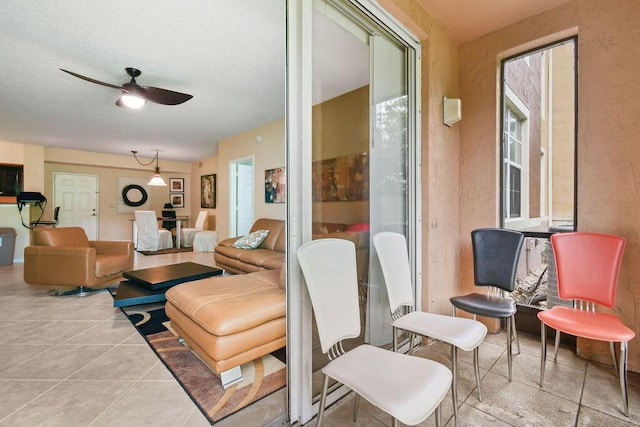 interior space featuring light tile flooring and ceiling fan