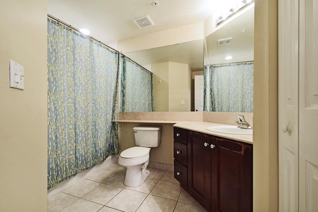 bathroom with tile flooring, oversized vanity, and toilet