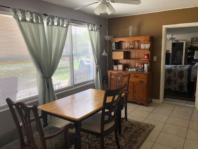 dining room featuring light tile floors and ceiling fan