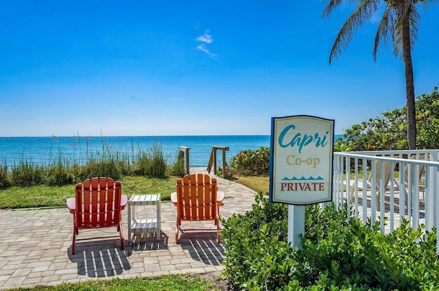 community / neighborhood sign featuring a water view