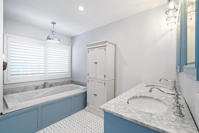 bathroom featuring a tub, vanity, and tile flooring