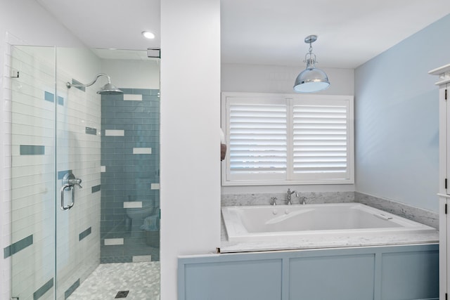 bathroom featuring separate shower and tub