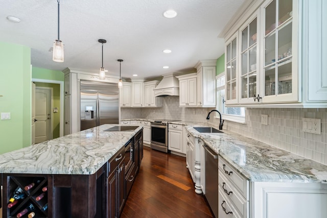 kitchen featuring a center island, appliances with stainless steel finishes, dark hardwood / wood-style flooring, custom range hood, and sink