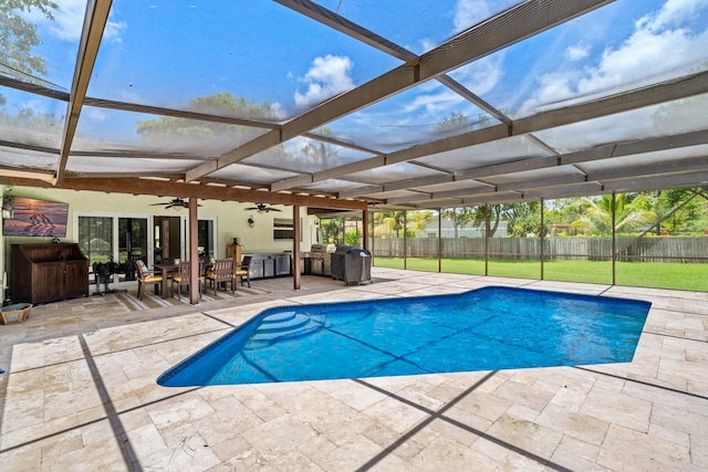 view of swimming pool with area for grilling, ceiling fan, and a patio