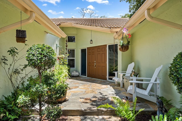 view of exterior entry featuring a patio