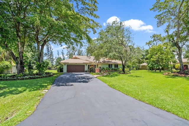 view of front of home featuring a front yard and a garage