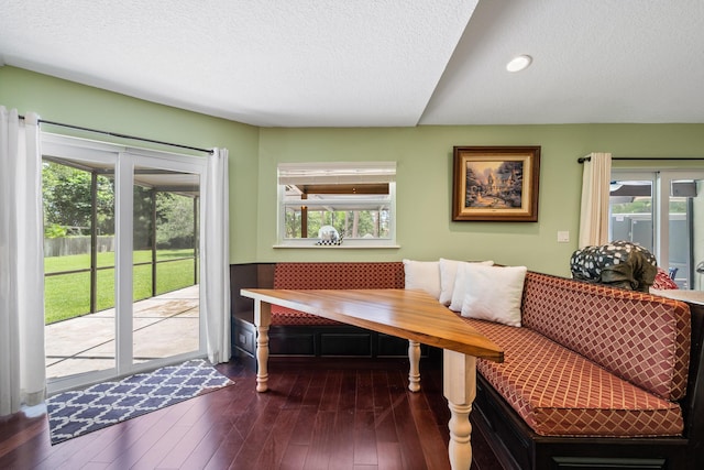 dining area featuring a textured ceiling and dark hardwood / wood-style floors