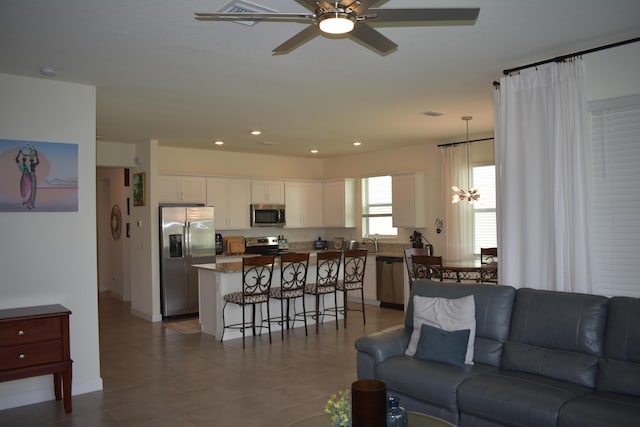 tiled living room with ceiling fan