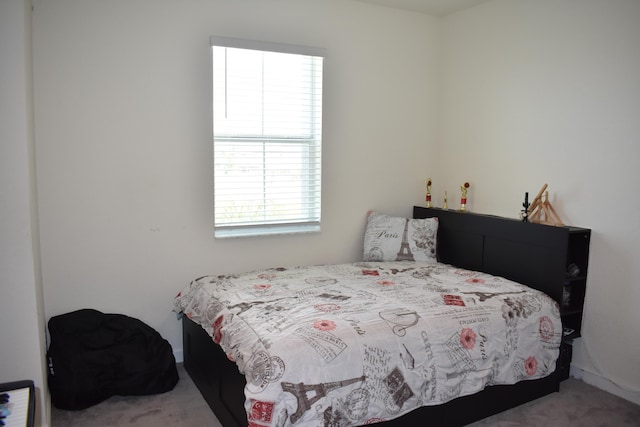 carpeted bedroom featuring multiple windows